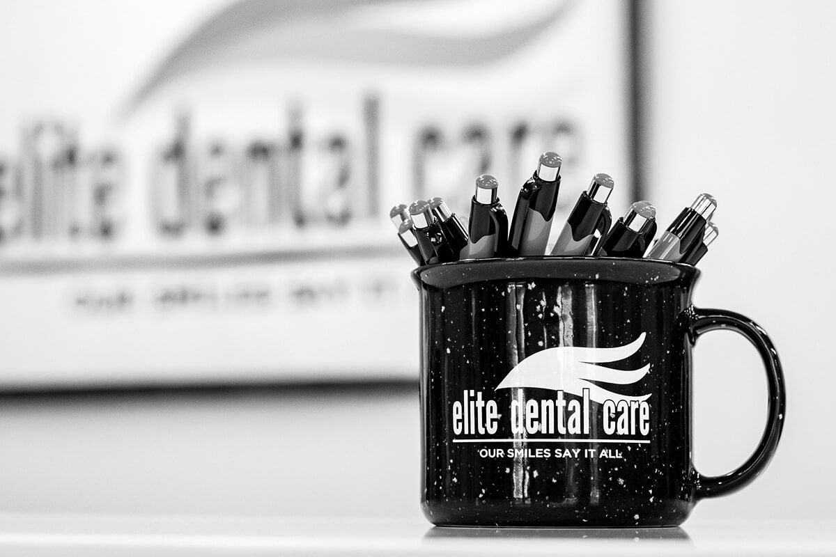 Cup of Elite Dental Care pens in lobby