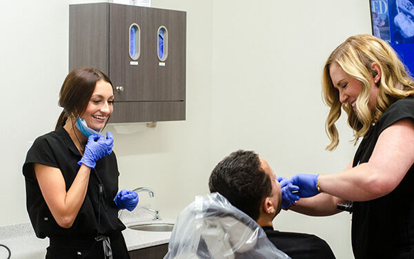 Dr. Kate and Alyssa working on a patient