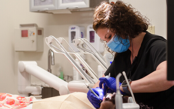 Carla doing hygienist work at the Jackson office